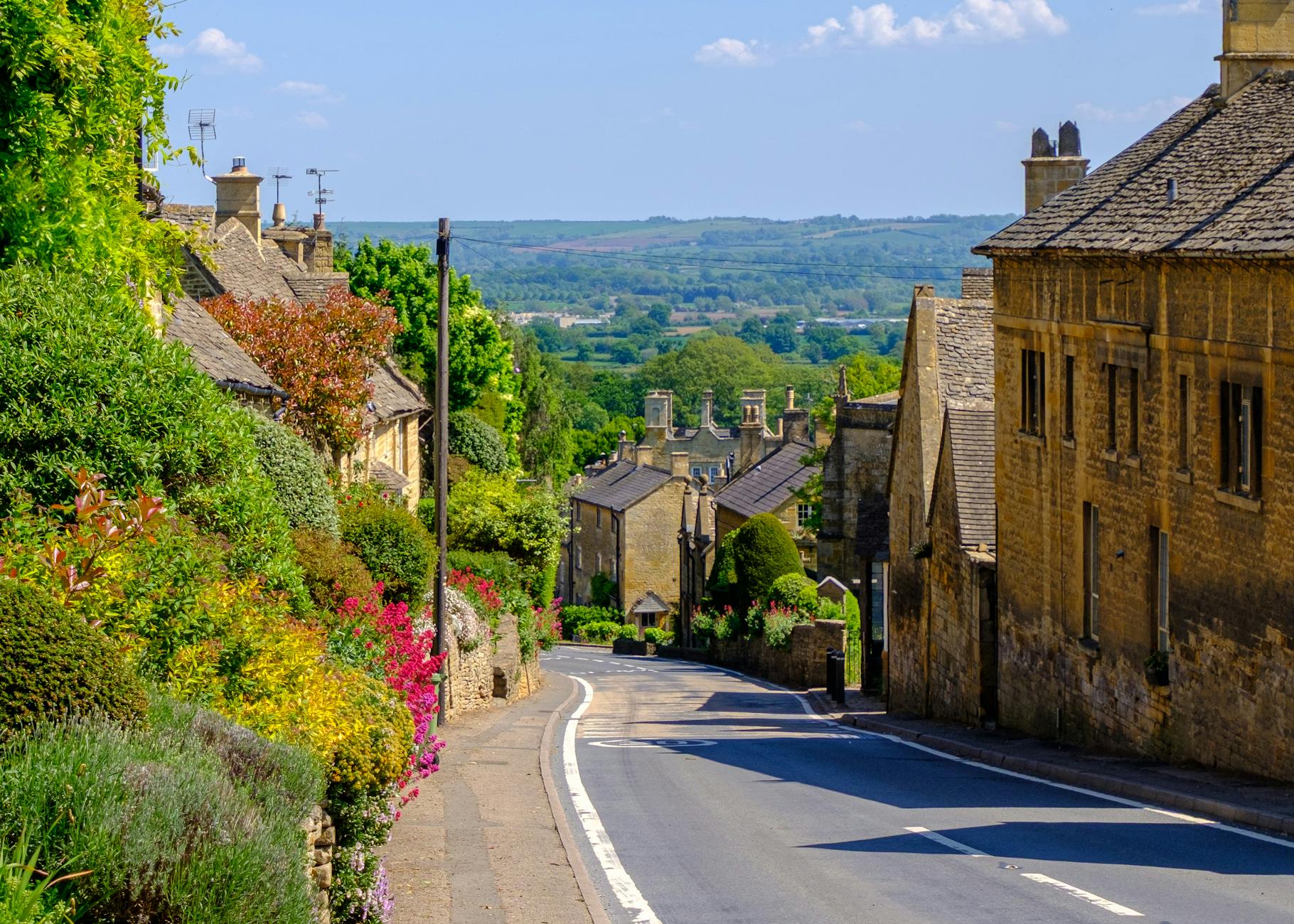 Bourton-on-the-Water village centre with stone bridges crossing the River Windrush in the Cotswolds