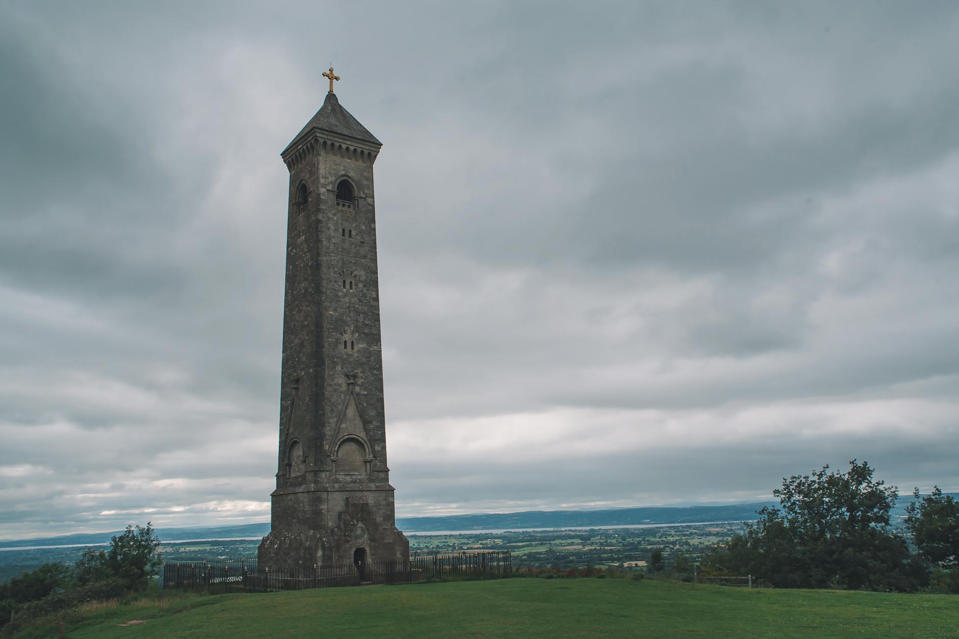 A hilltop tower landmark surrounded by green countryside