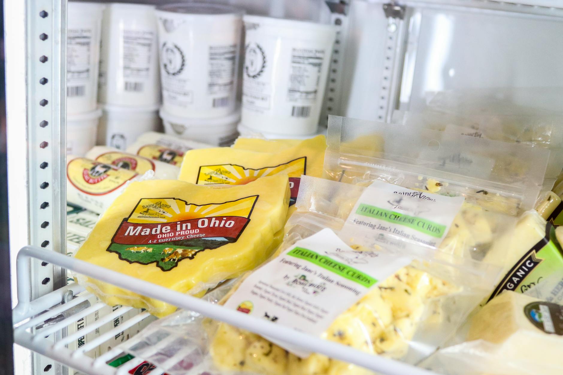 A well-stocked farm shop displaying local cheeses and artisan produce in the Cotswolds
