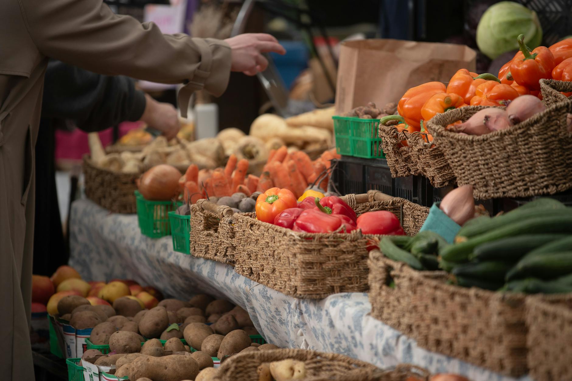 Fresh produce stalls at a busy farmers market