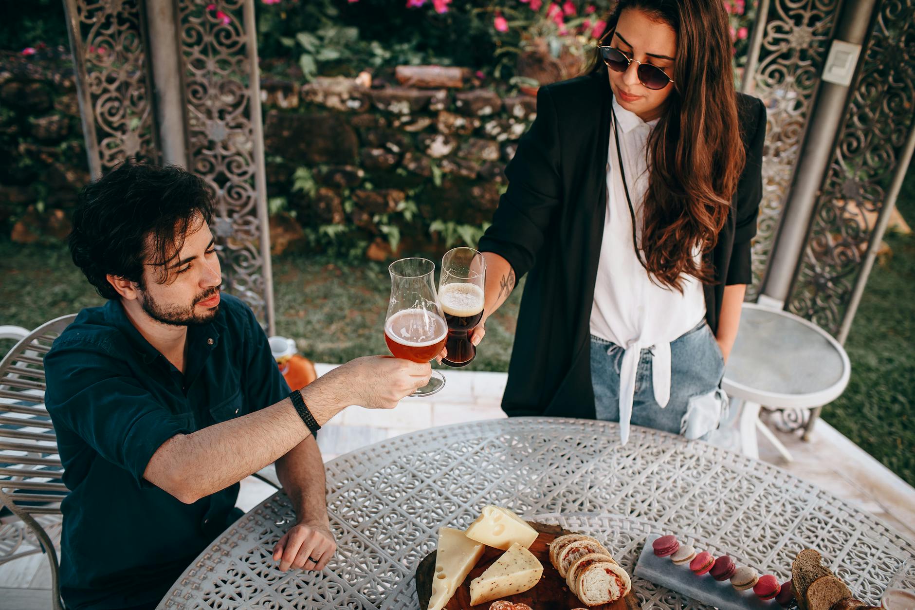 Diners enjoying lunch in the sunny garden of a Cotswolds gastropub