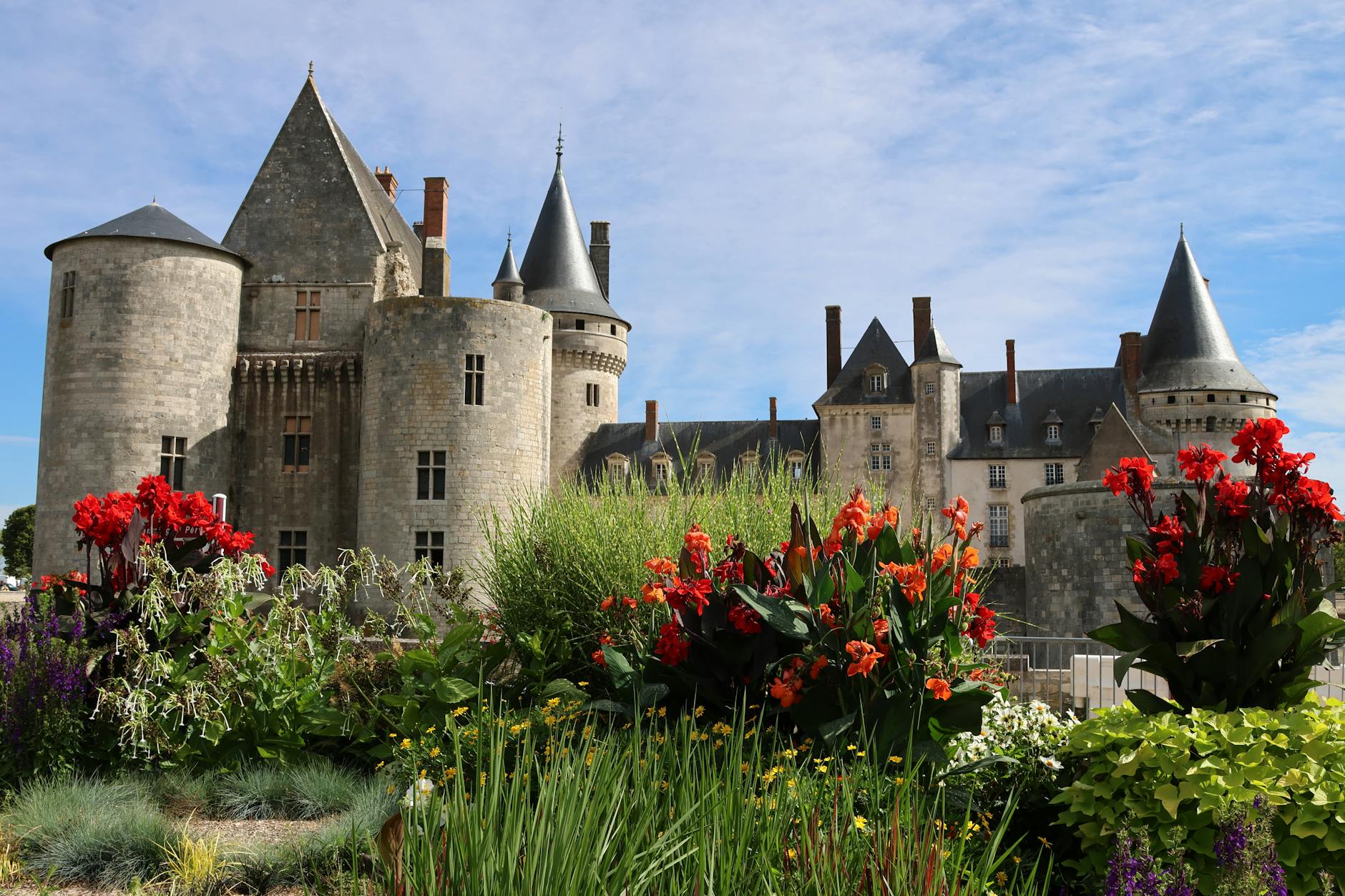 Historic castle surrounded by manicured gardens in the English countryside