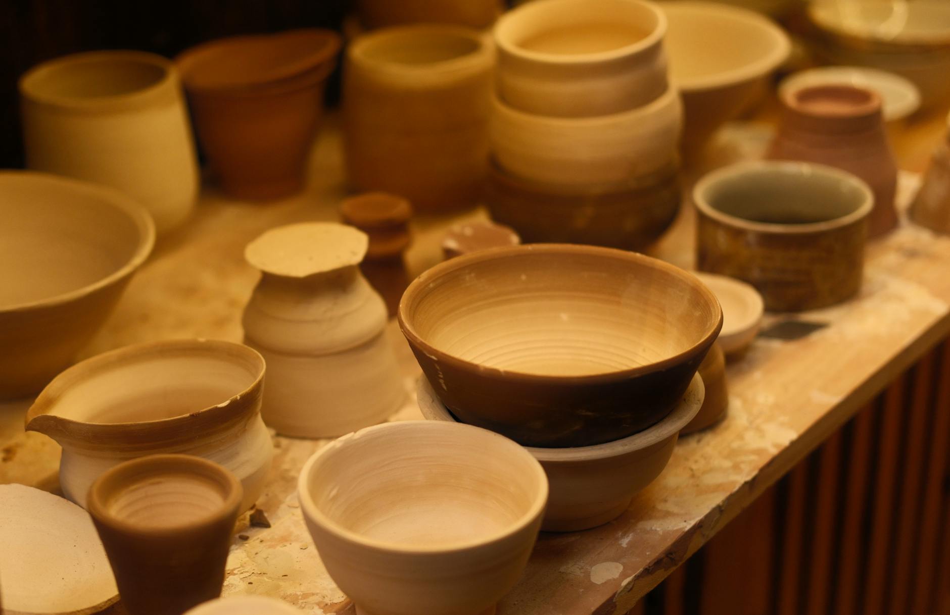 An artisan at work in a pottery workshop creating handmade ceramics