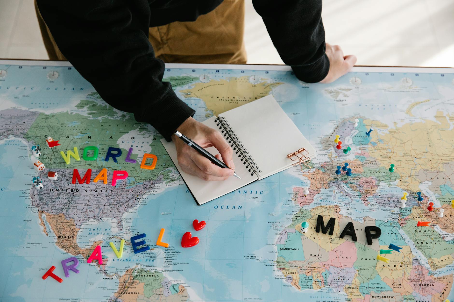 A travel map and notebook laid out for trip planning