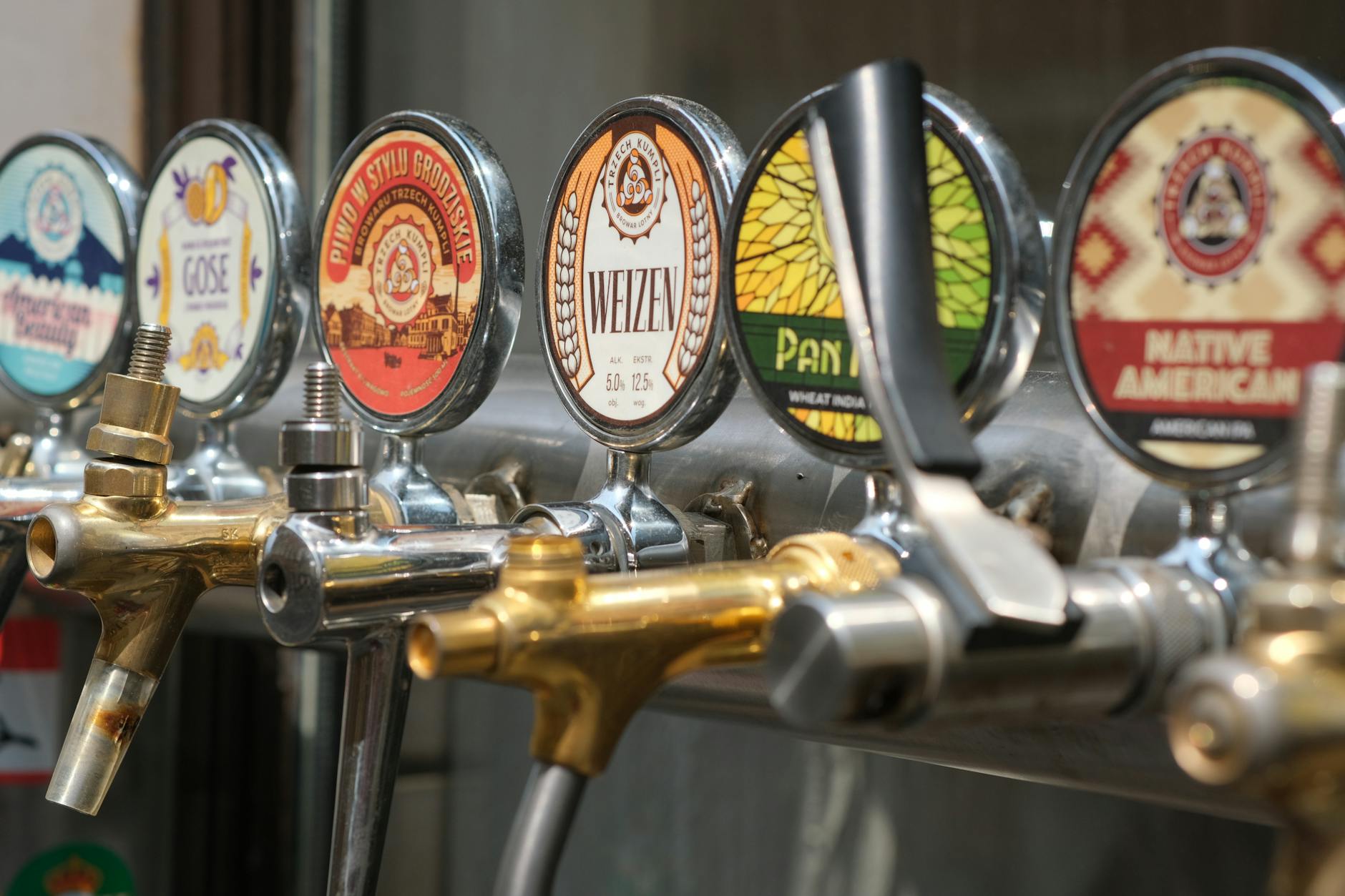 Craft beer taps and golden ales at a Cotswolds brewery taproom
