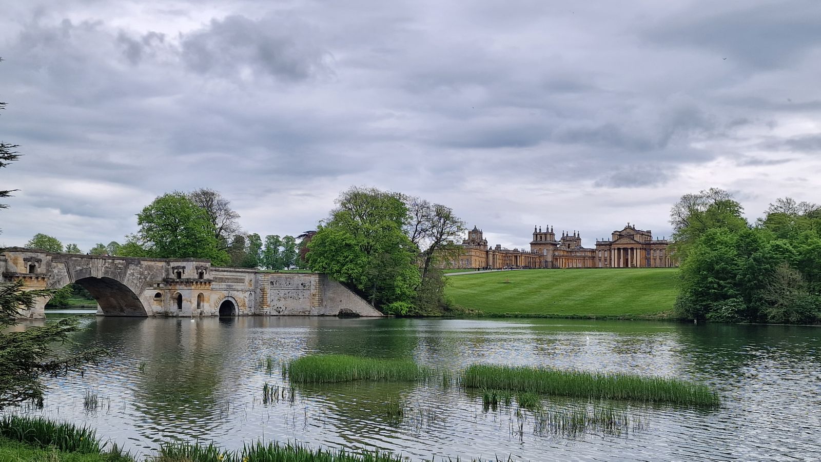 Blenheim Palace and its Grand Bridge reflected in the lake landscaped by Capability Brown