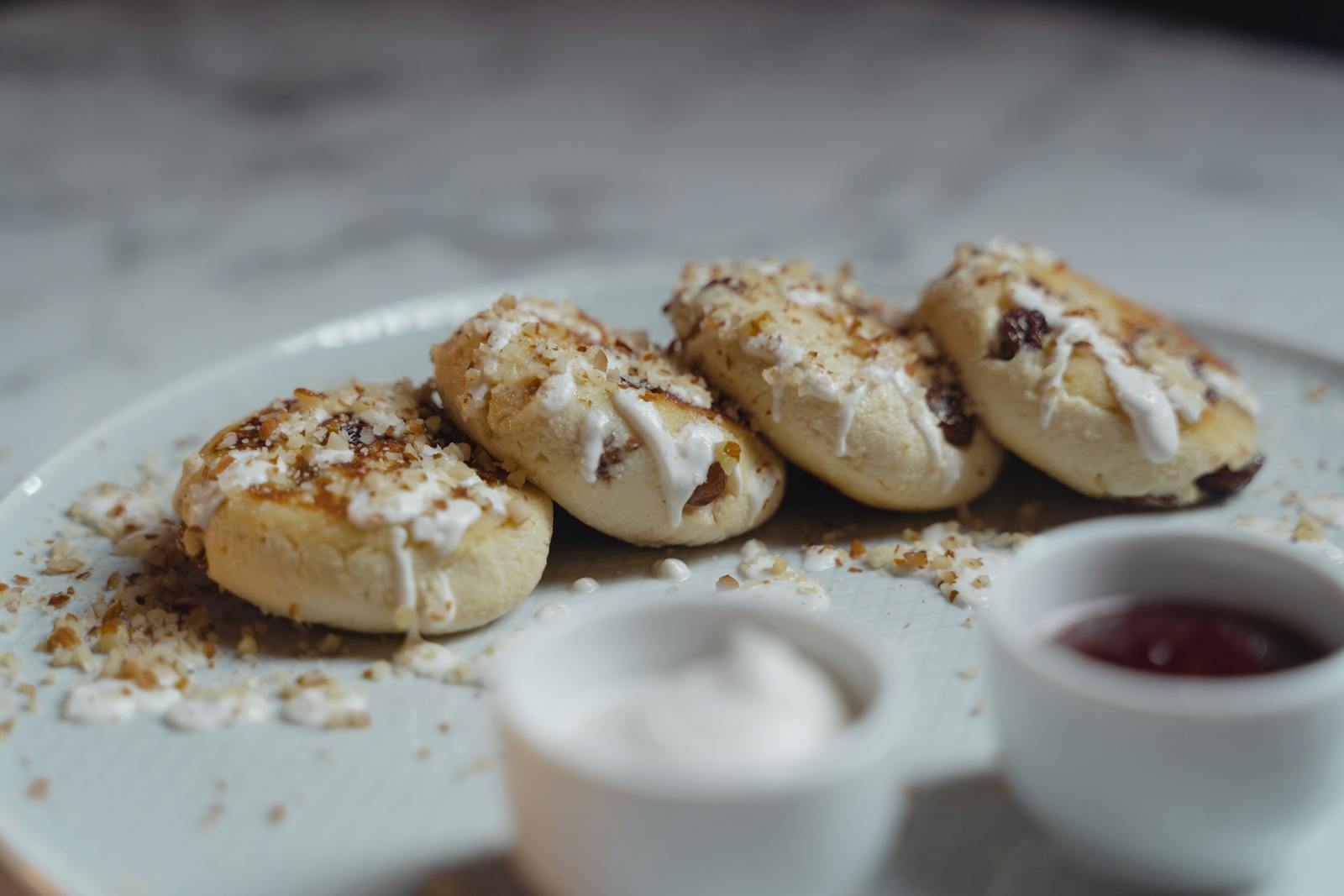 Freshly baked scones topped with clotted cream and jam