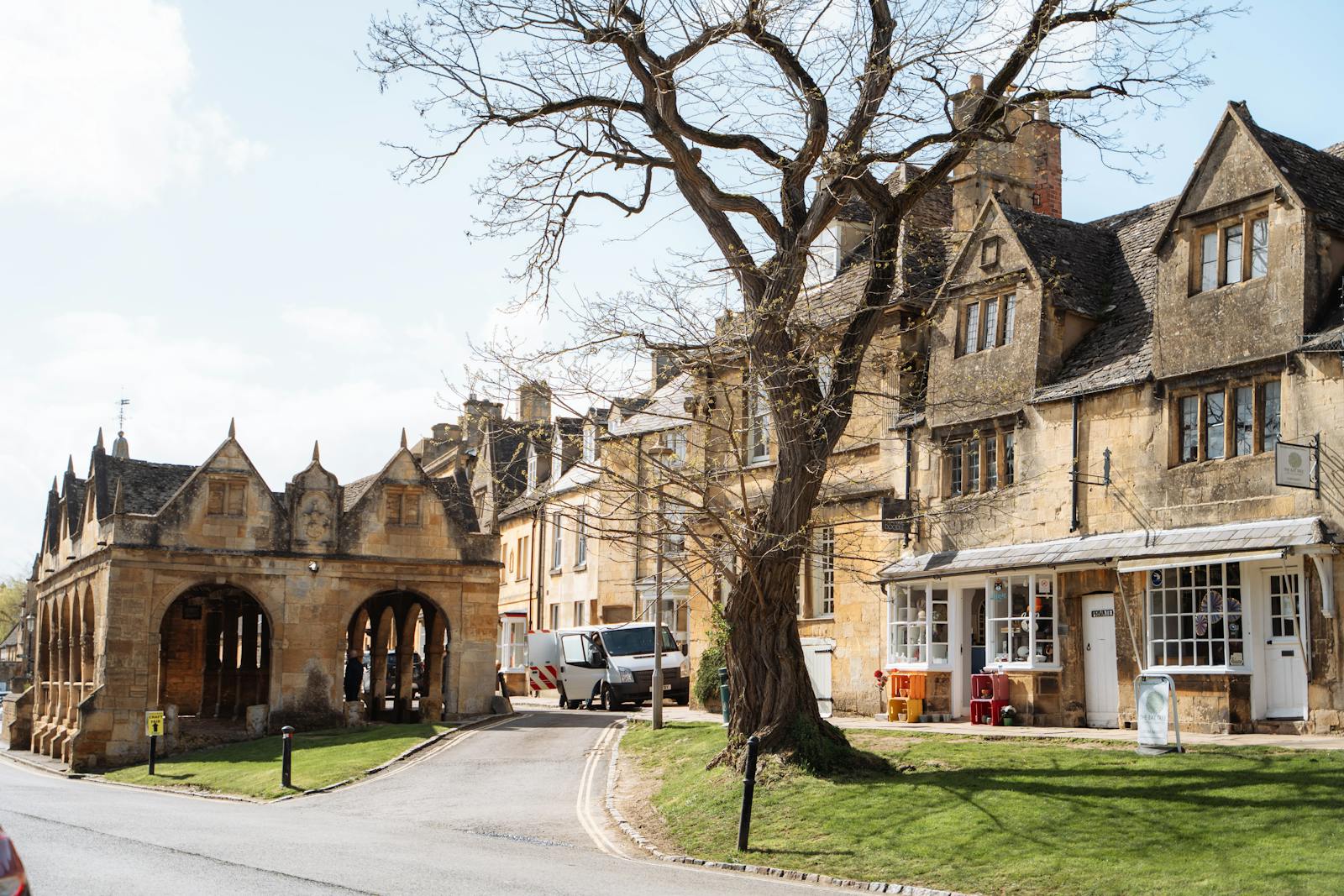 Honey-coloured Cotswold stone buildings and a historic market hall in a Cotswold town