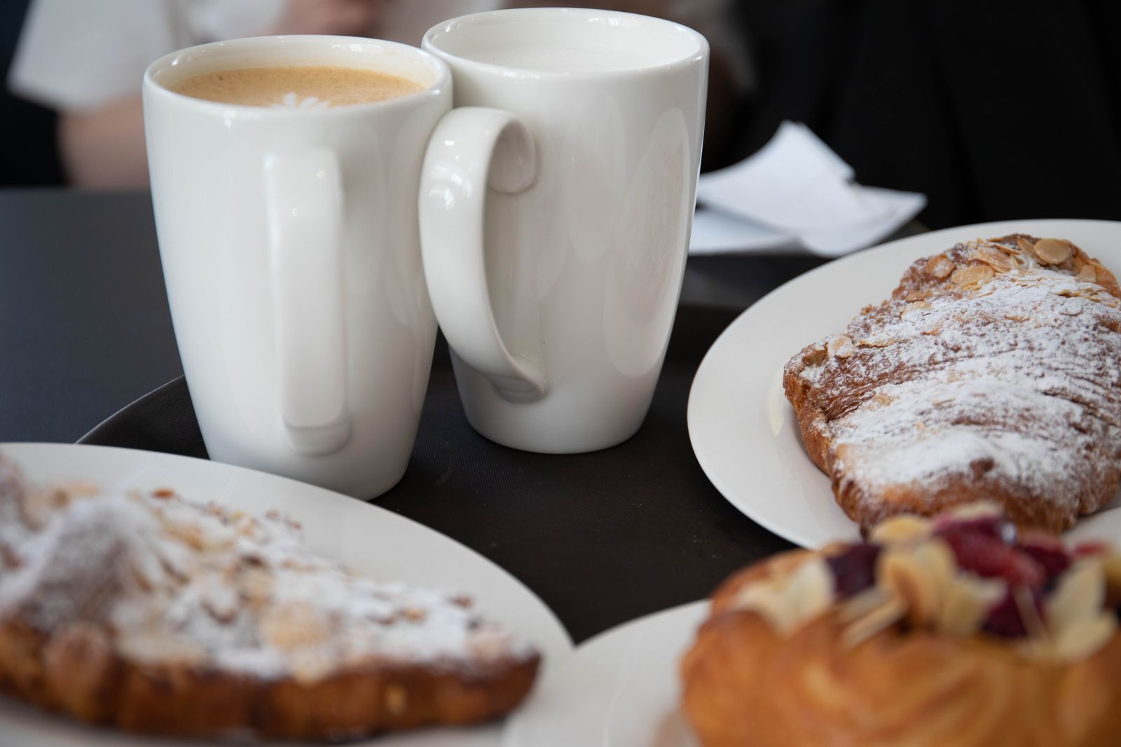 Coffee and croissants served on a cosy cafe table