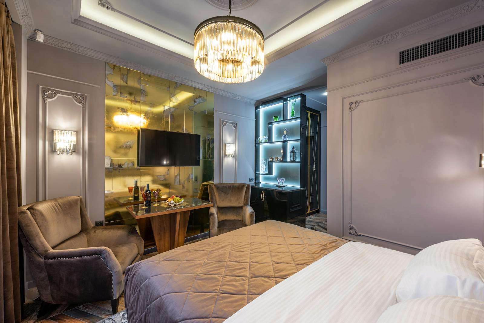 A comfortable hotel room with a large bed and seating area