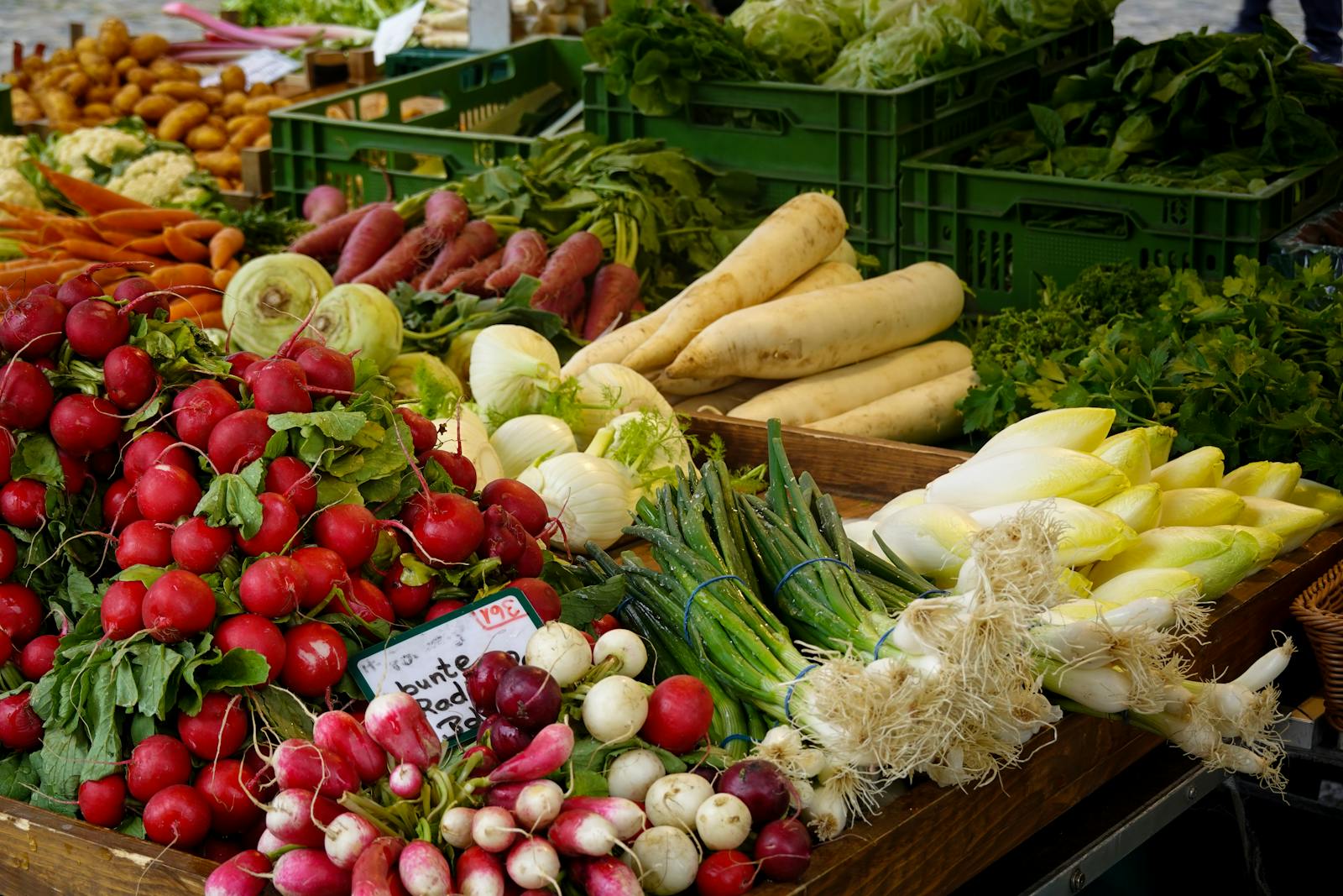 A colourful array of fresh vegetables at a farmers market stall