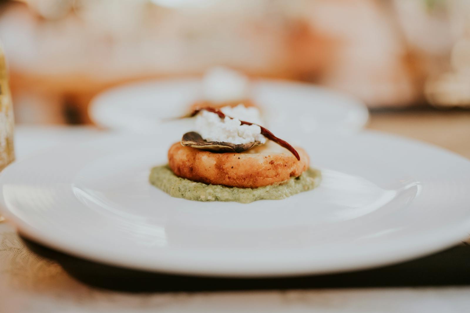 A gourmet starter elegantly plated on a white plate in a restaurant