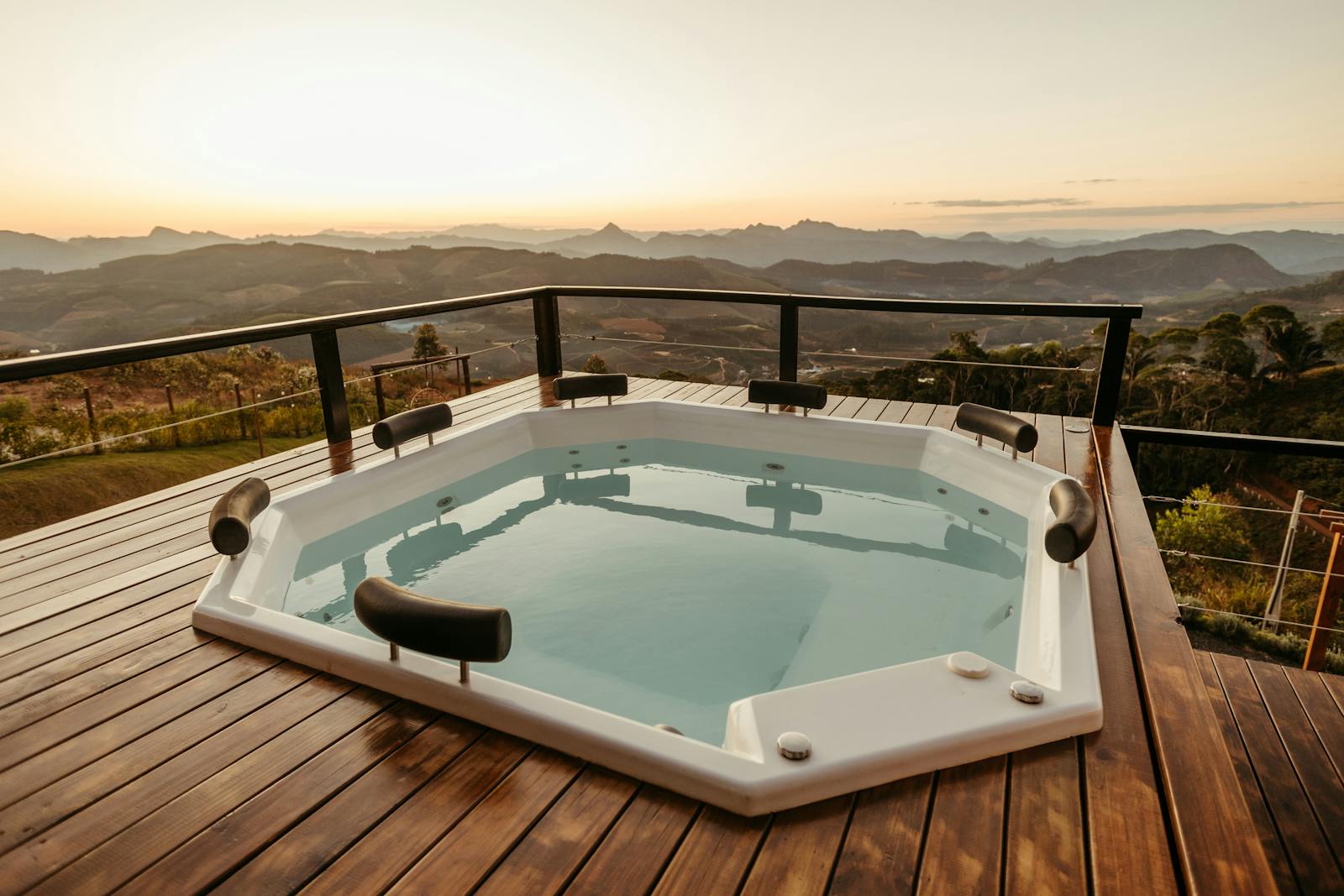 A relaxing outdoor hot tub with a scenic view at sunset