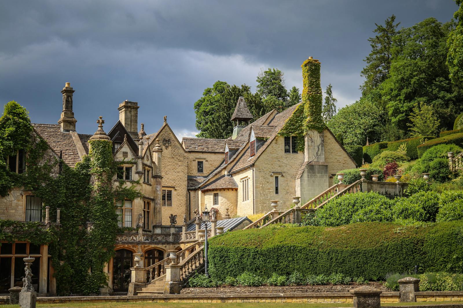 A historic English manor house hotel surrounded by manicured green gardens