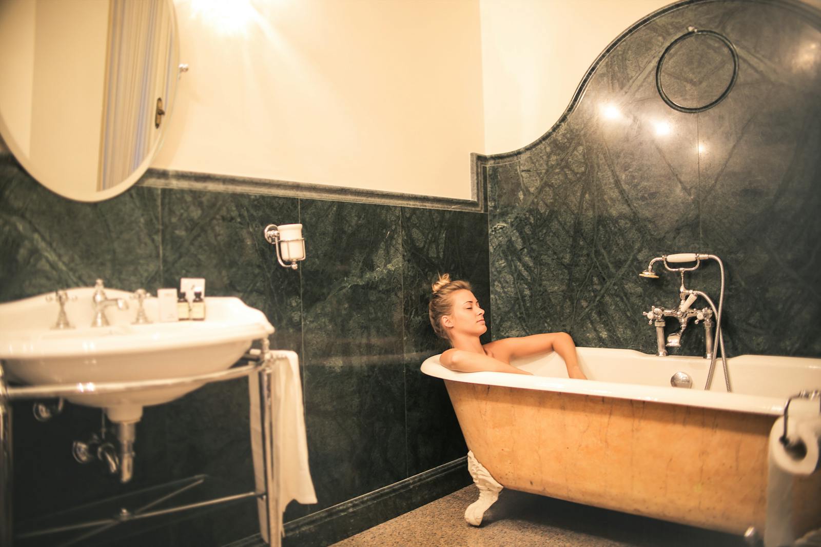 A luxurious hotel bathroom with a freestanding roll-top bath