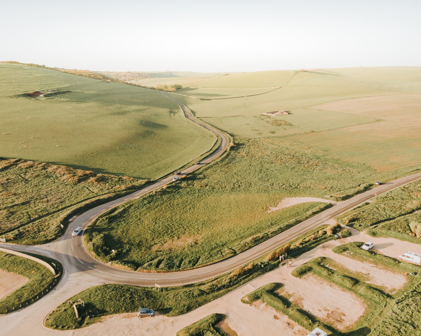 A winding country road through the rolling Cotswolds countryside