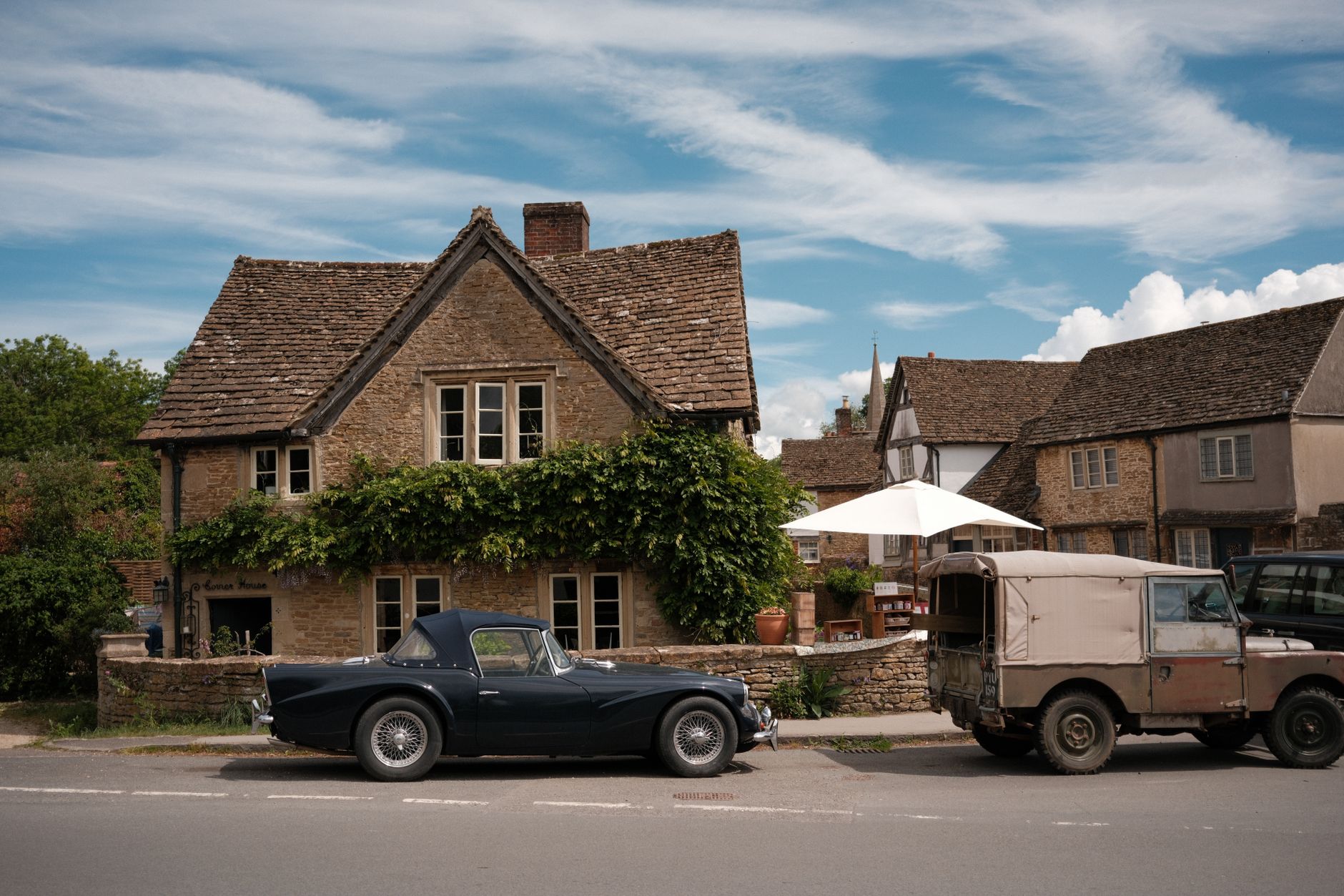 A classic honey-stone Cotswold village street with cottages