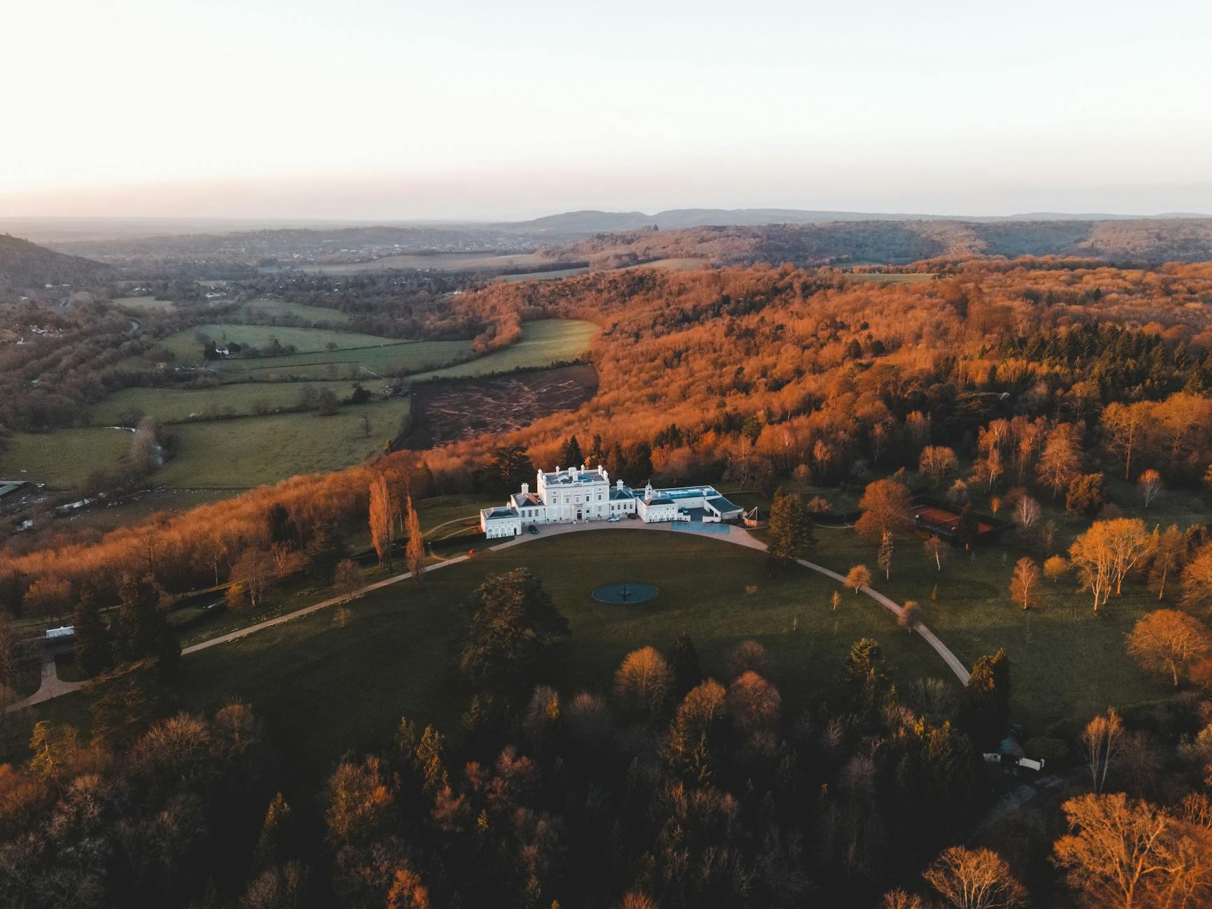 A historic English castle surrounded by autumn grounds