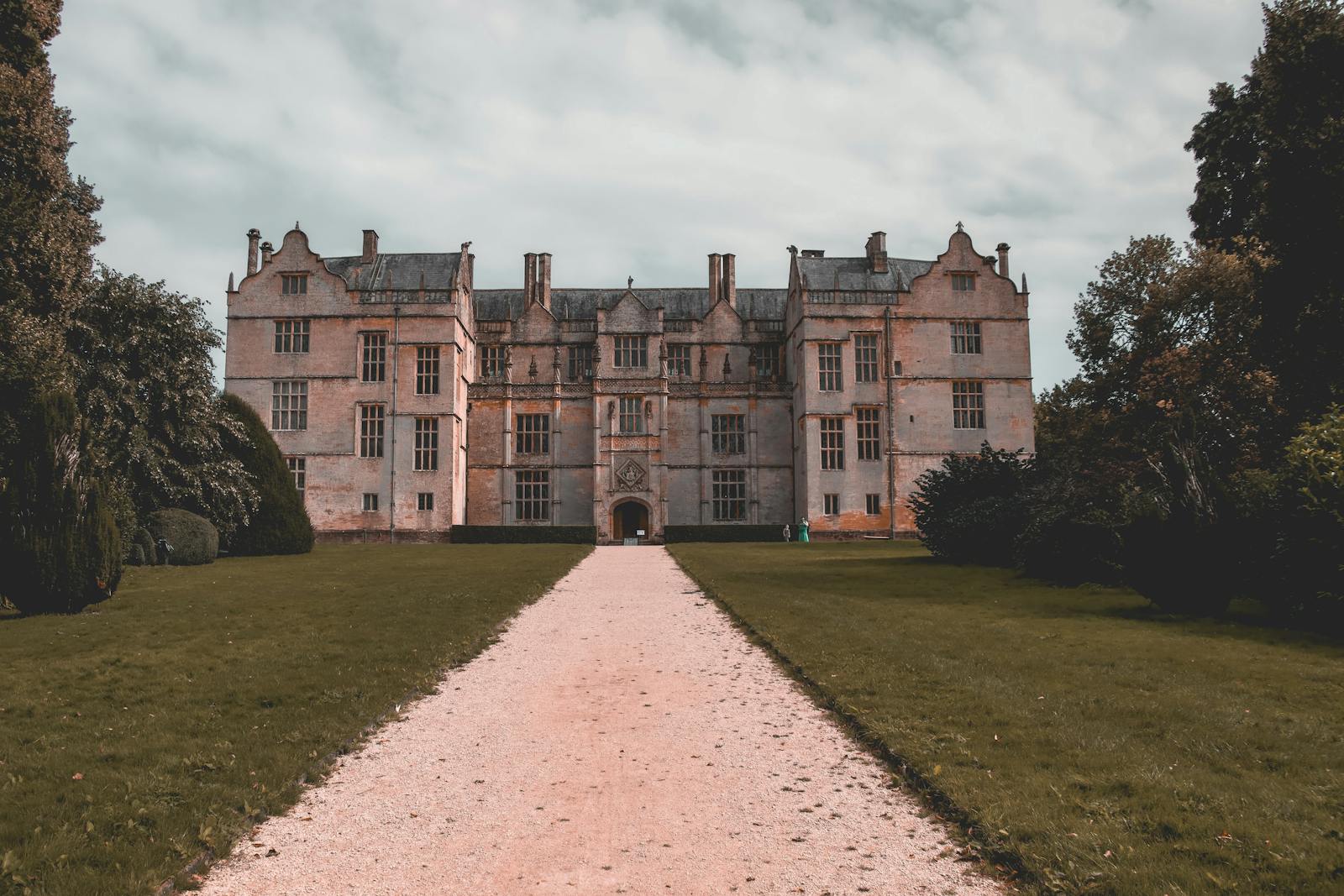 A historic Elizabethan-style English manor house and gardens linked to the Arts and Crafts movement