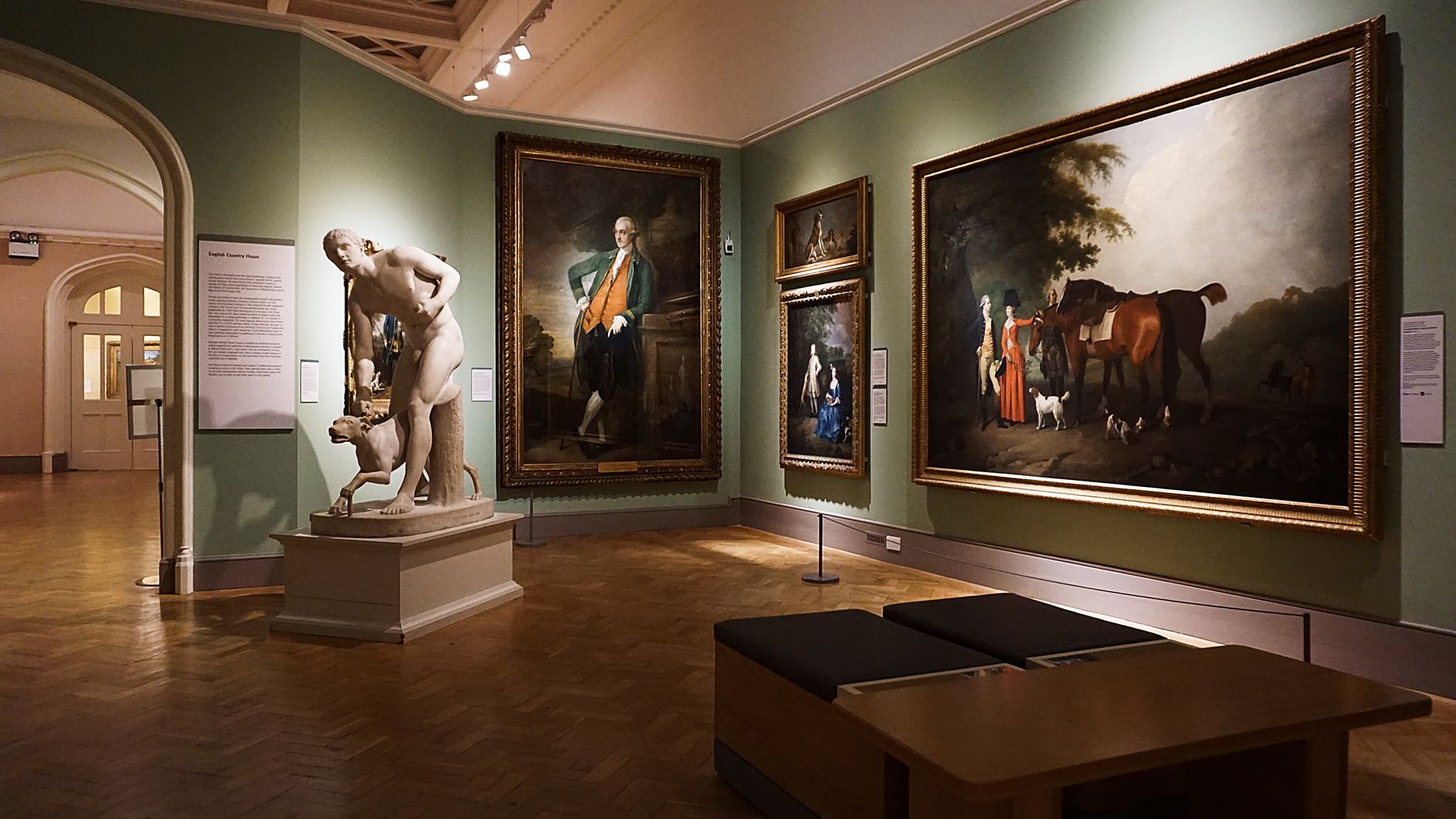 Interior of a Cotswolds art gallery hung with paintings