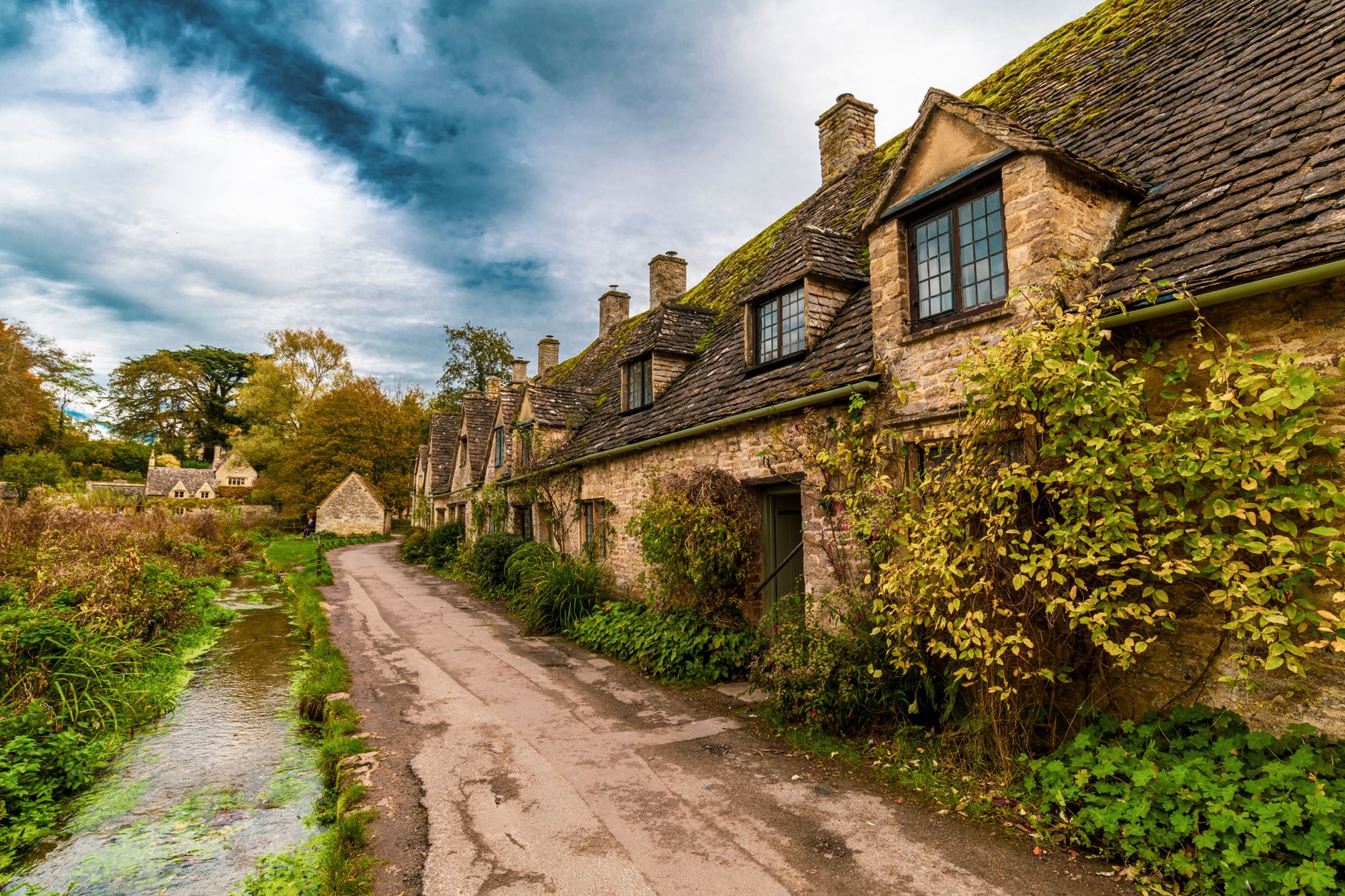 Stone cottages along a quiet road in Bibury in the Cotswolds