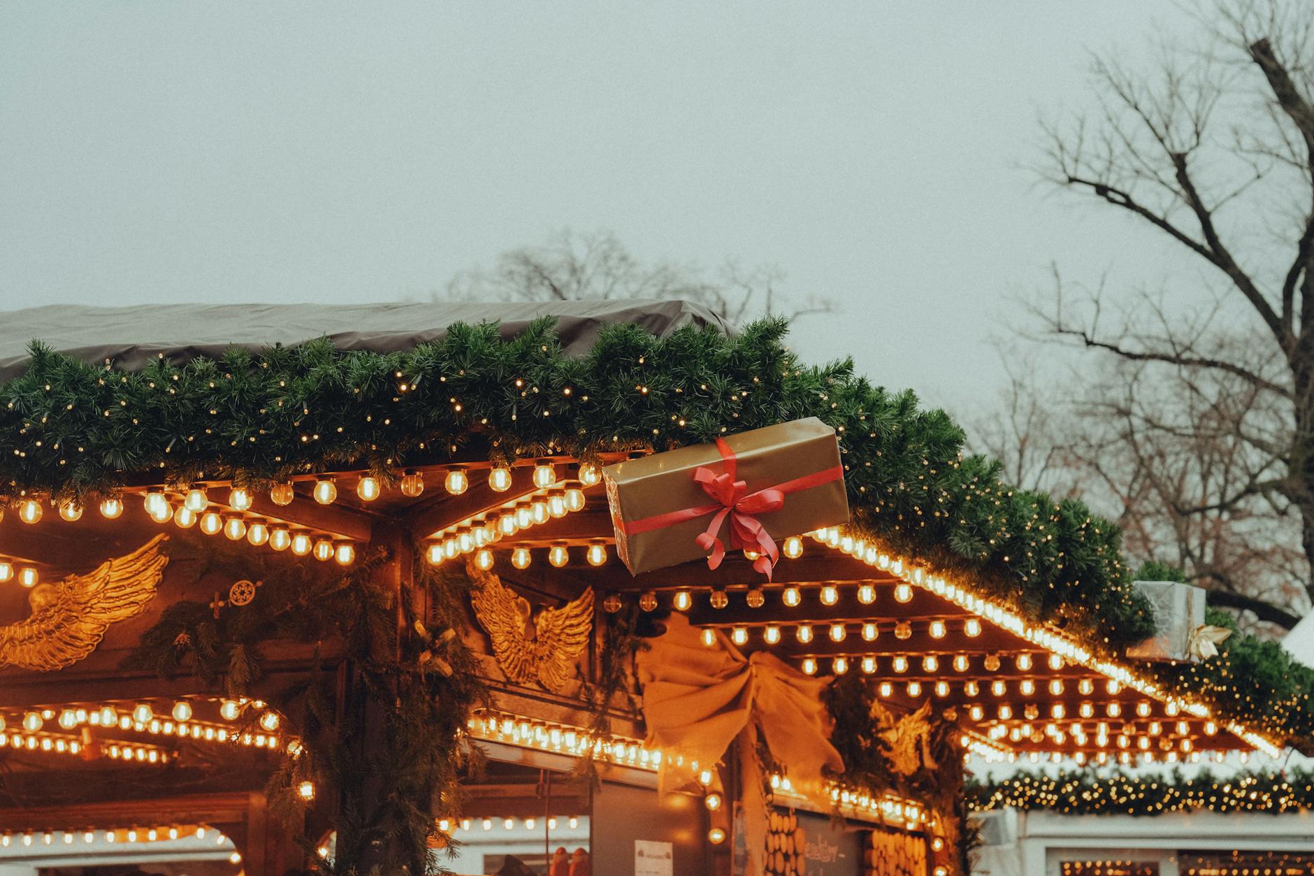A Christmas market stall adorned with lights and decorations in the Cotswolds