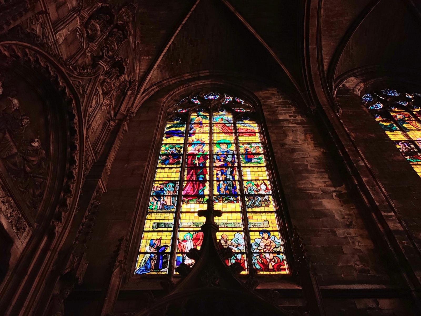 Vibrant medieval-style stained glass windows in a Gothic church interior