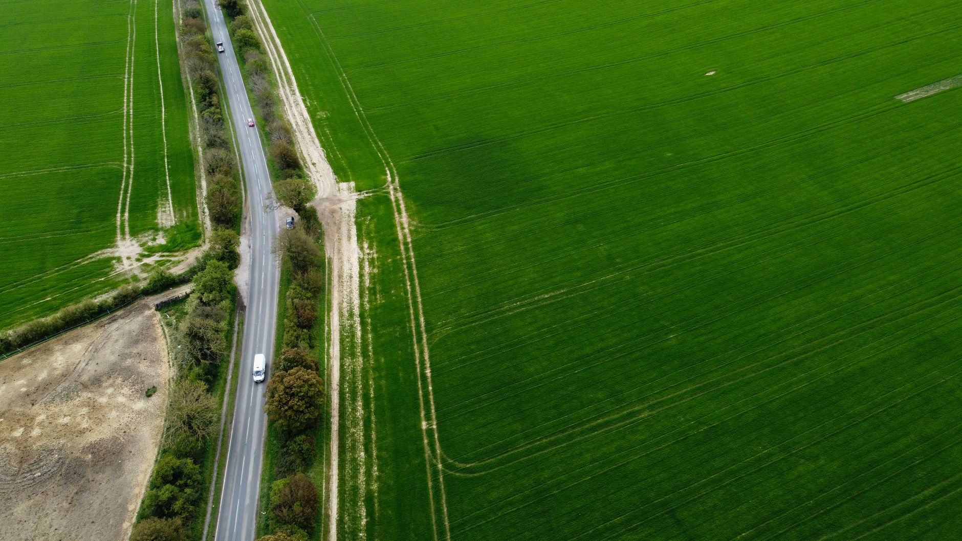 A country road through green hills into the Cotswolds