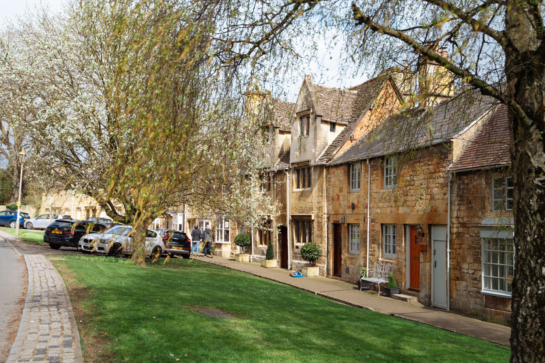 Honey-stone Cotswold cottages with blossom, an easy escape from Birmingham