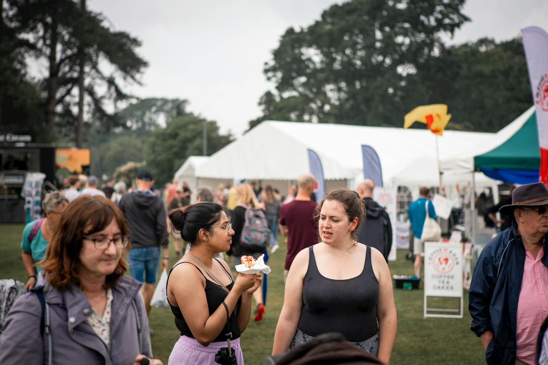 Visitors browsing food and drink stalls at a busy outdoor festival