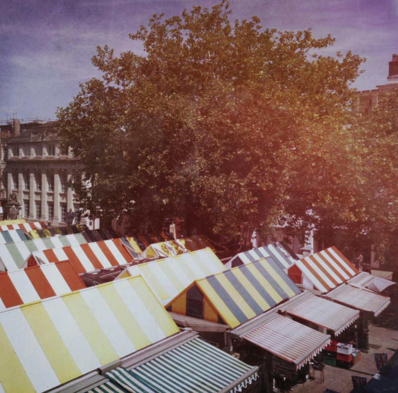 Open-air market stalls in a Cotswolds market town