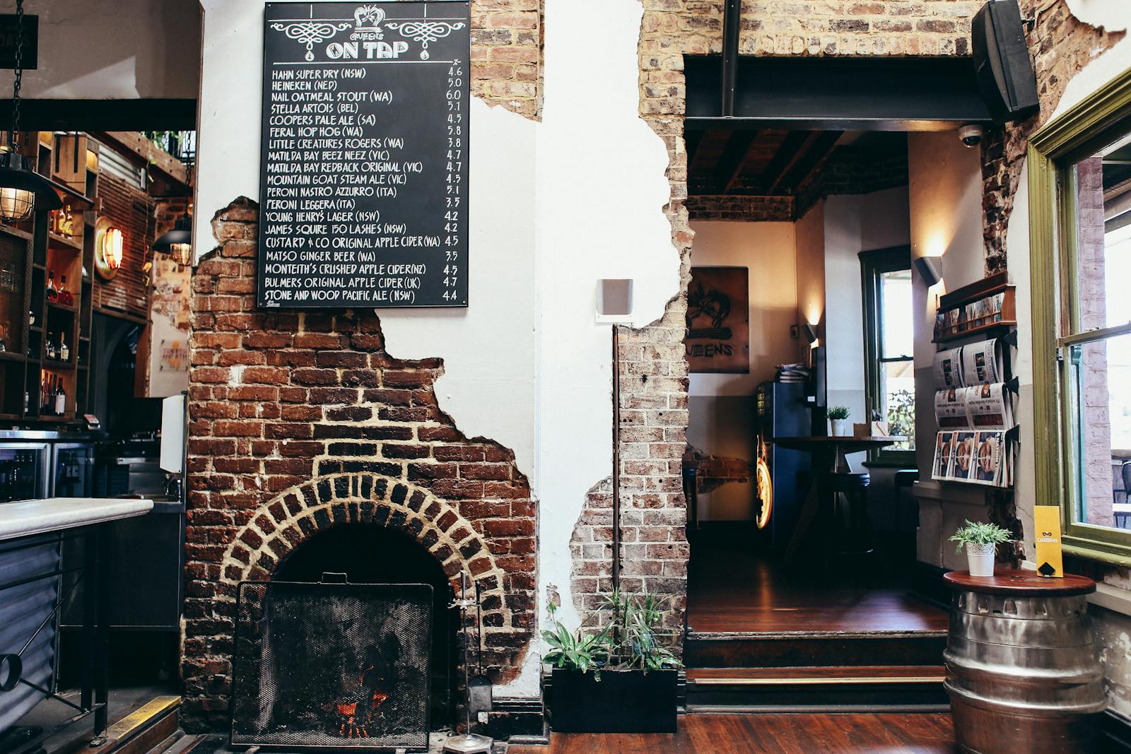 The rustic interior of a traditional old English pub with a blackboard menu