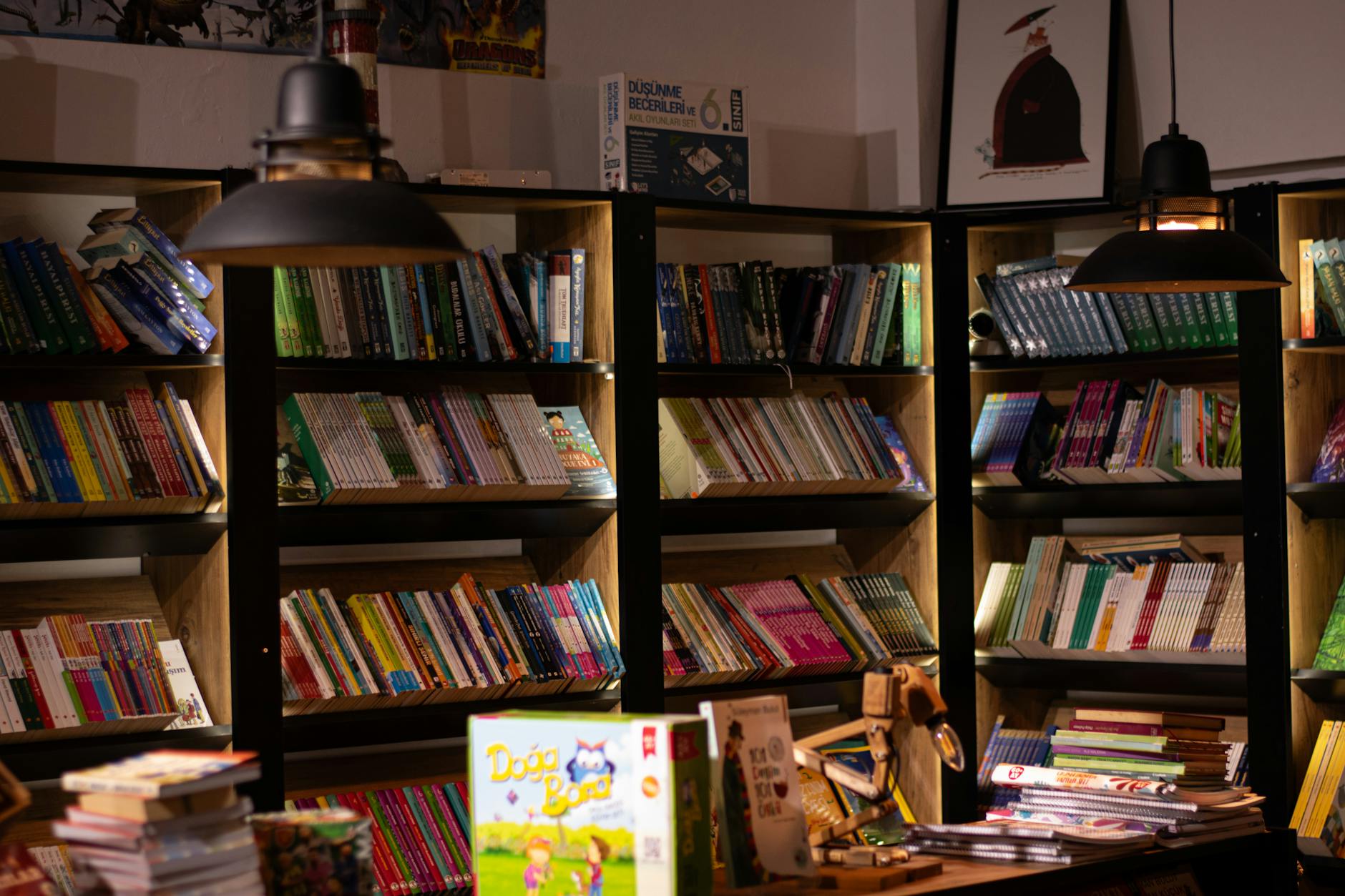 Cosy interior of an independent Cotswolds bookshop with warmly lit shelves