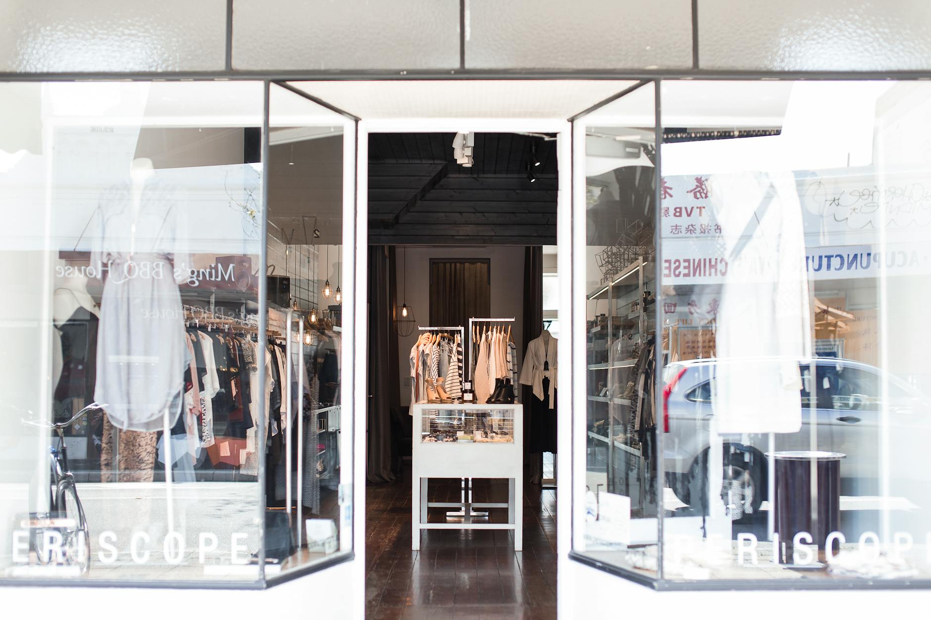 An independent boutique shopfront with stylish window display in a Cotswolds town