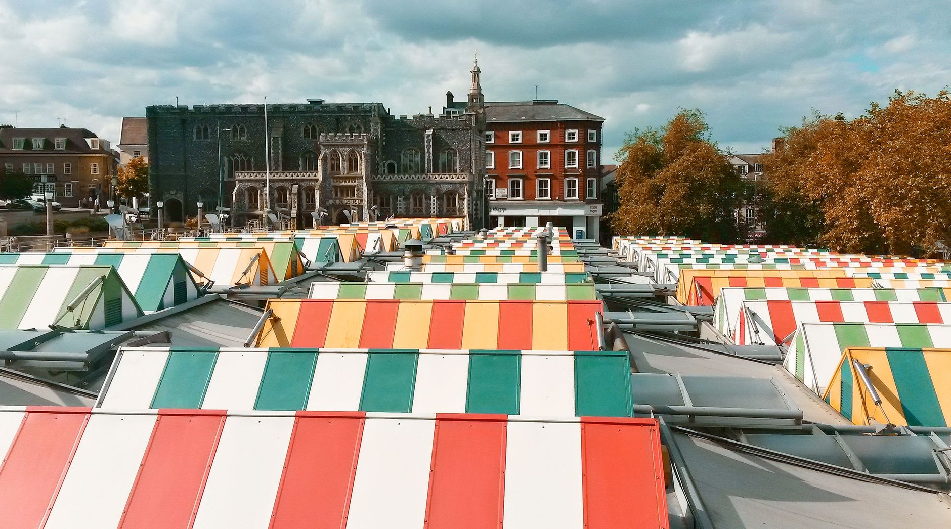 Colourful open-air market stalls along a town street