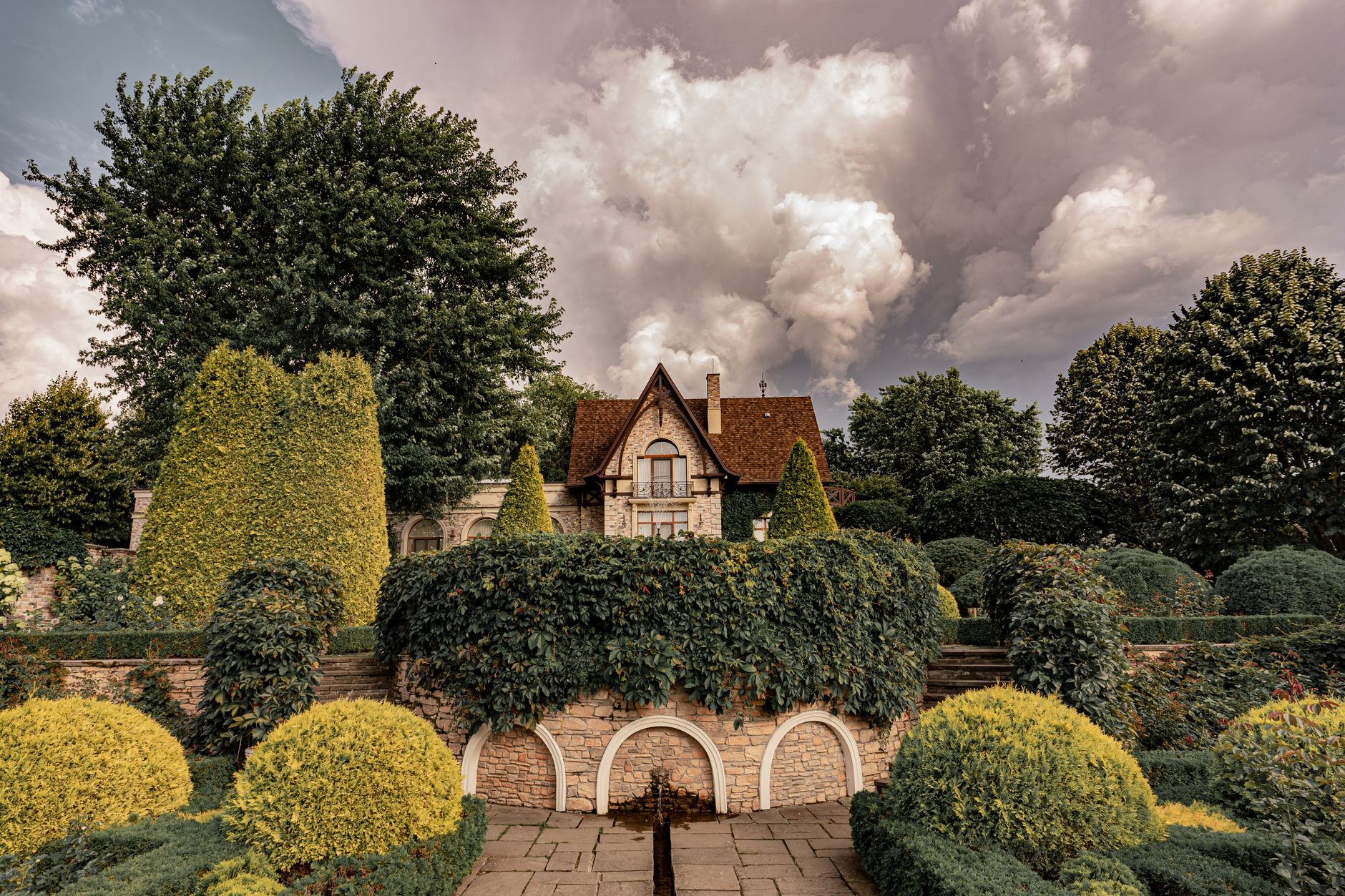 A north Cotswolds manor garden with topiary, such as Hidcote