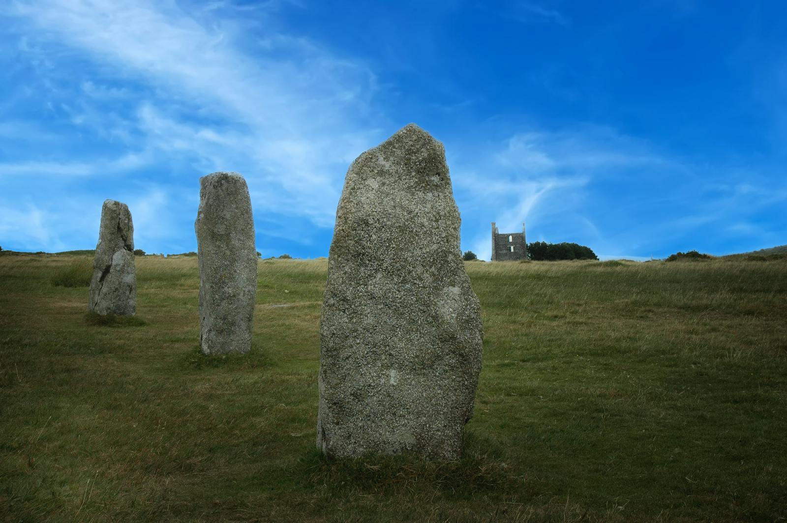 An ancient prehistoric stone circle on a hilltop, like the Rollright Stones in the Cotswolds
