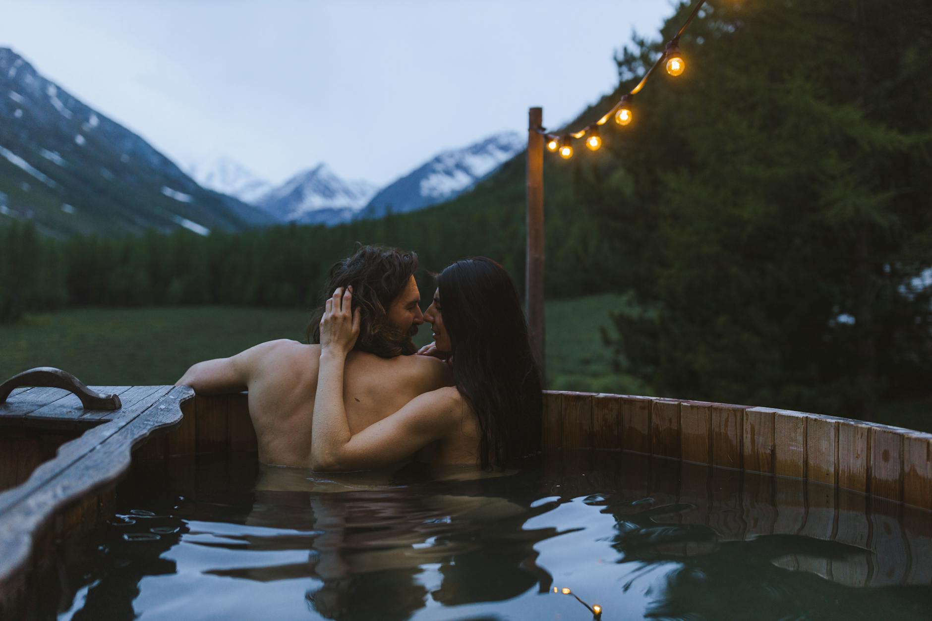 Couple relaxing in a private hot tub at a romantic Cotswolds cottage