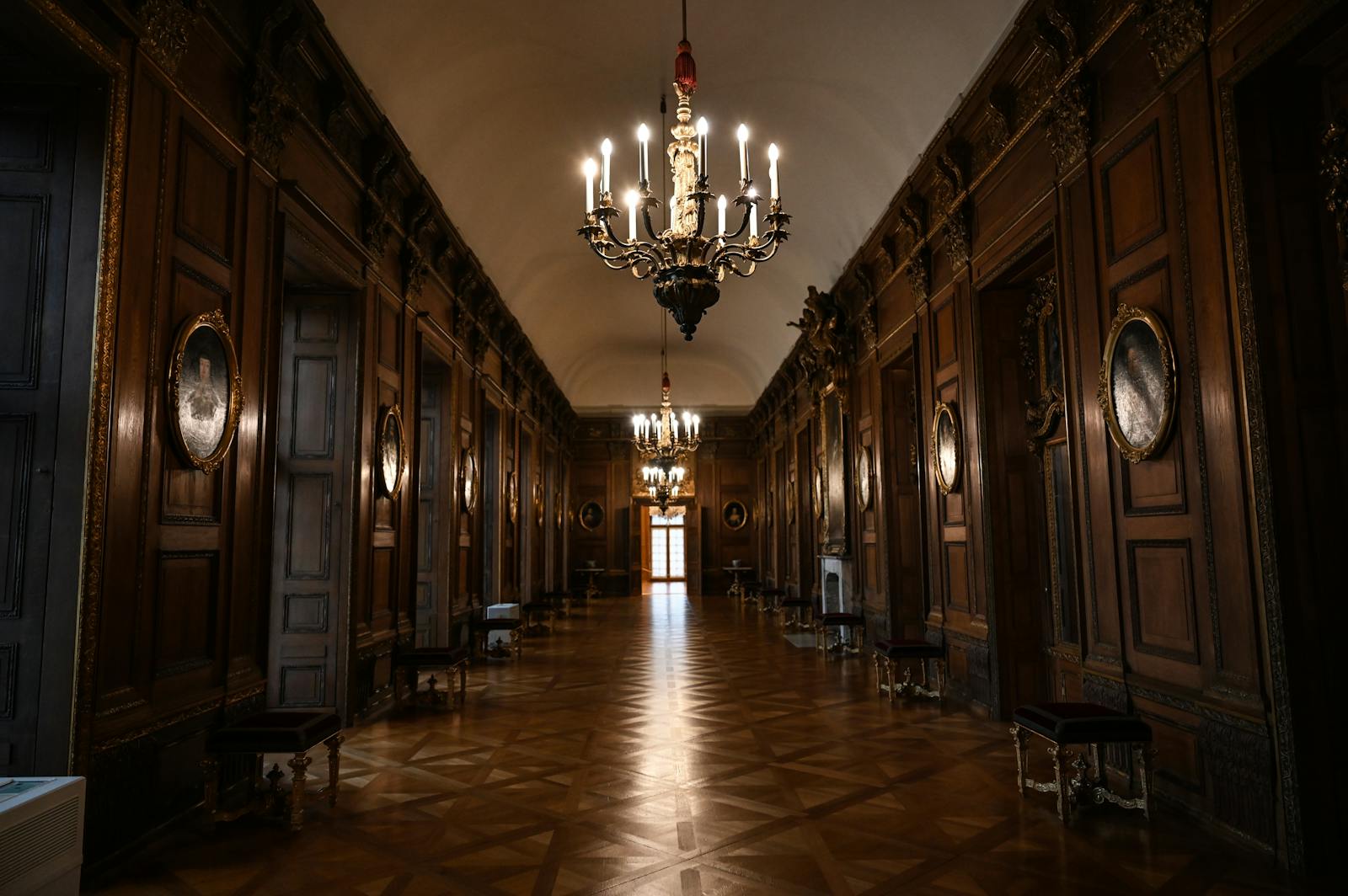 A grand chandelier-lit hall inside an English stately home