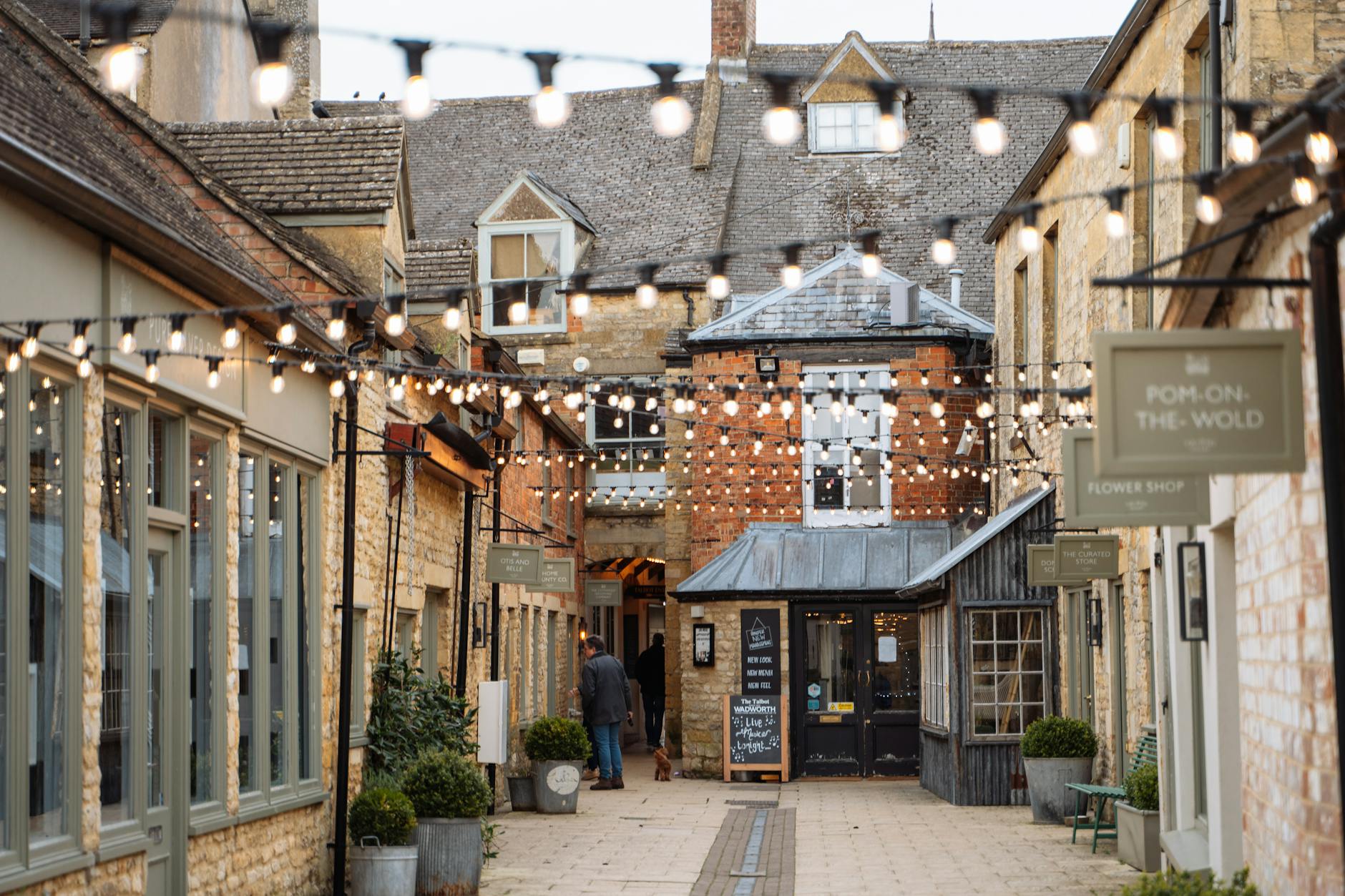 Honey-stone shops along a street in Stow-on-the-Wold, the Cotswolds