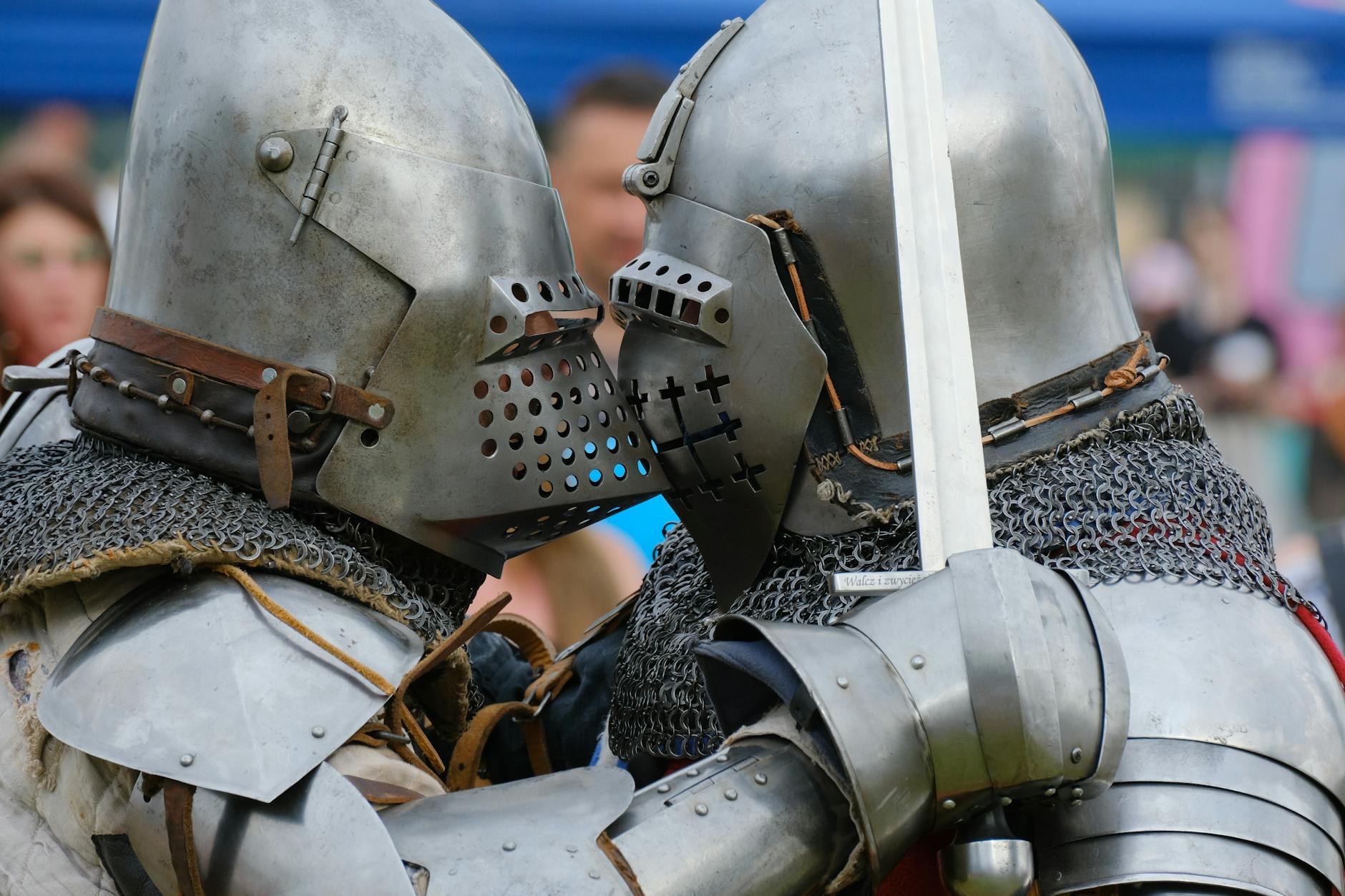 Two medieval knights in full armour fighting at a historical re-enactment