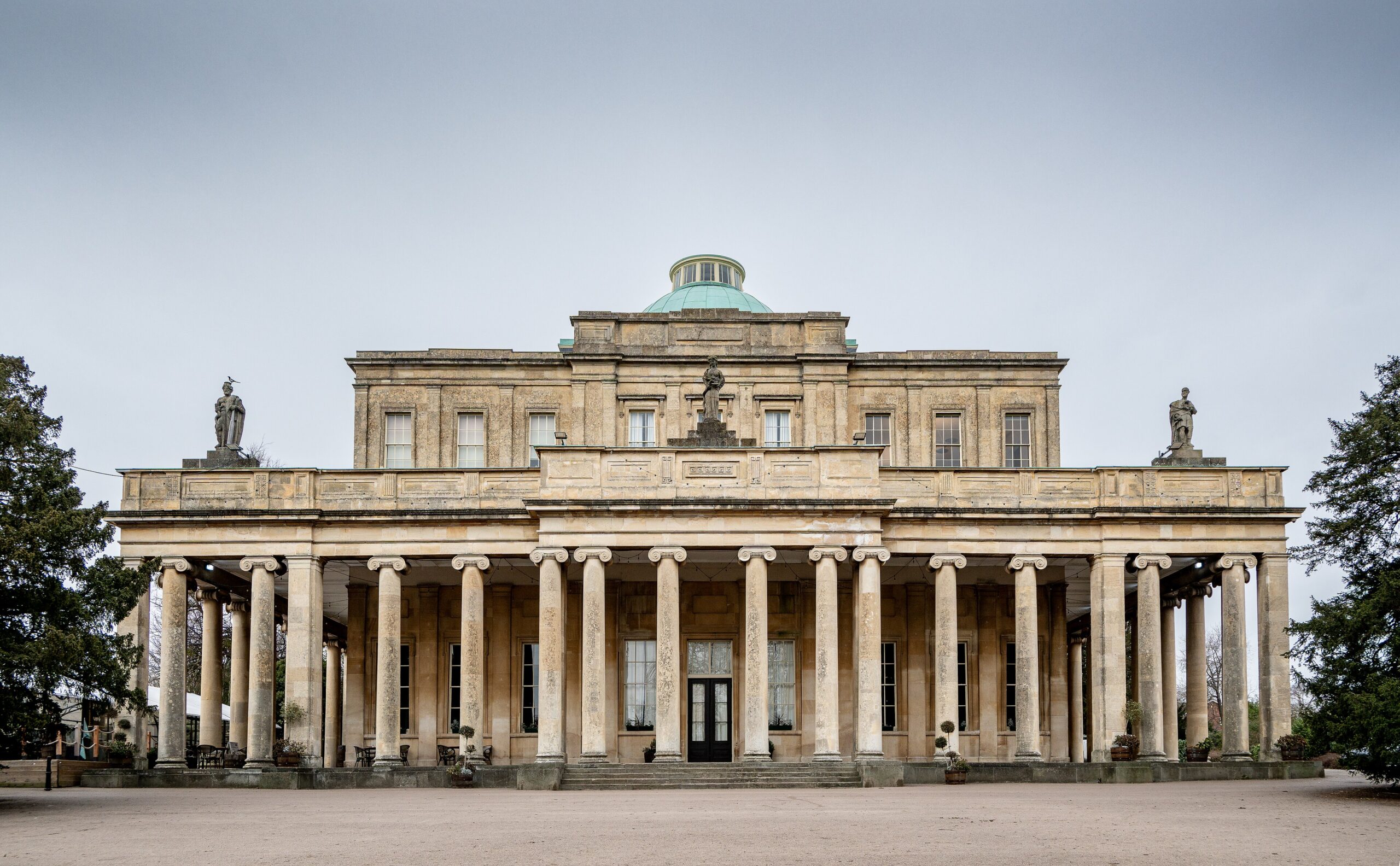 The Ionic colonnade and green dome of the Pittville Pump Room in Cheltenham