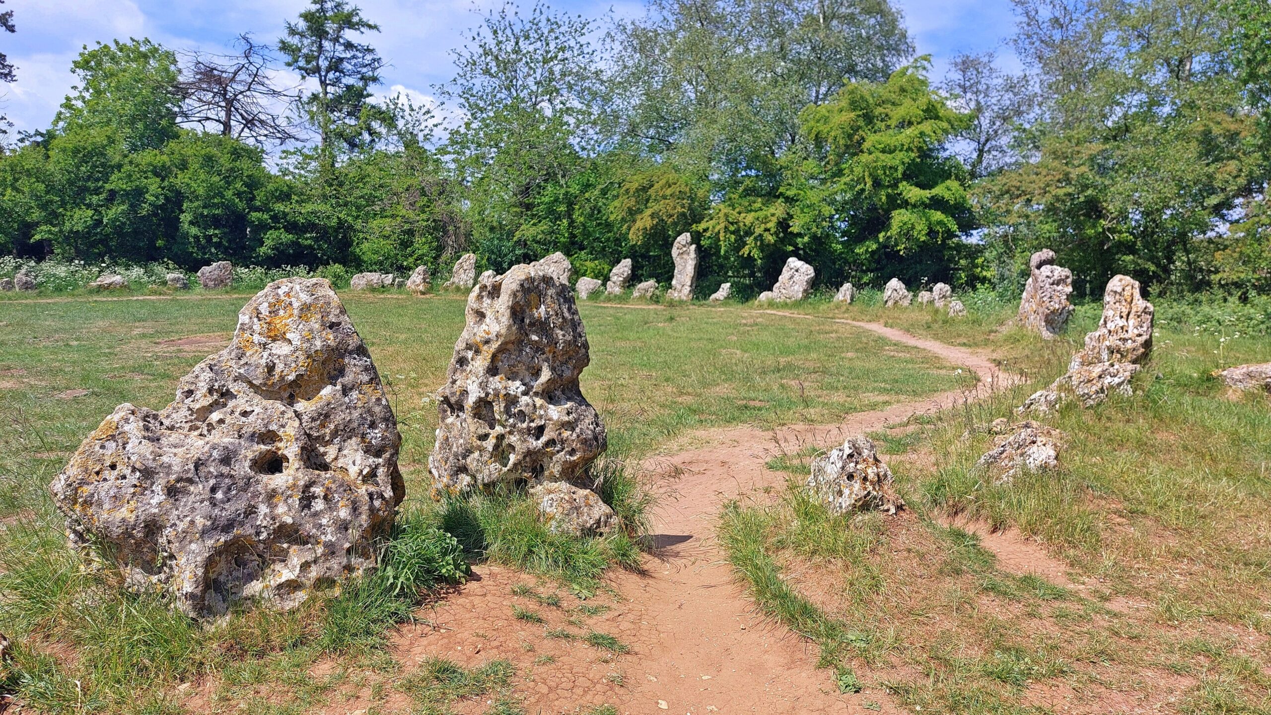 Weathered, deeply pitted limestone standing stones forming the King's Men circle at the Rollright Stones