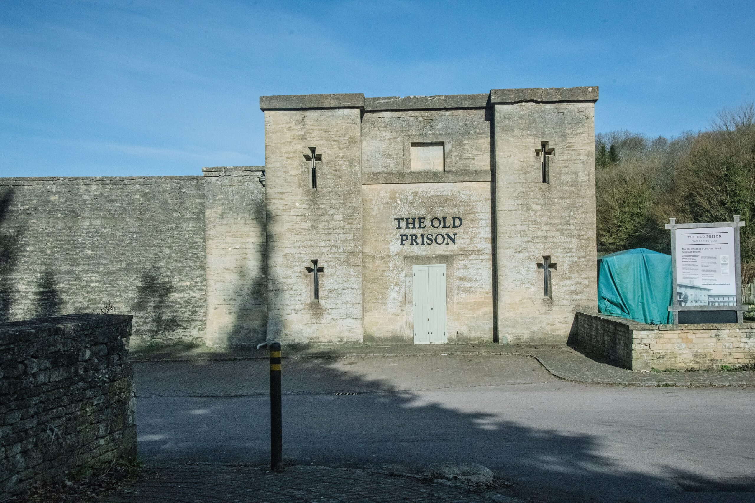 The stone gatehouse of the Old Prison at Northleach, with THE OLD PRISON carved above the door